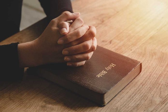 1801756960 featured image Hands praying on a Bible