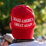 Red Make America Great Again hat on person's head