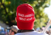 Red Make America Great Again hat on person's head