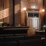 Empty courtroom with judge's bench and wooden decor.