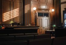Empty courtroom with judge's bench and wooden decor.