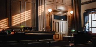 Empty courtroom with judge's bench and wooden decor.