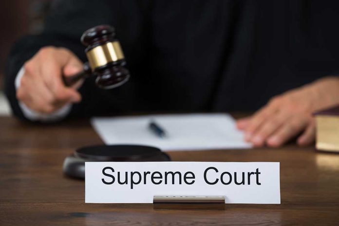 Judge with gavel and Supreme Court nameplate