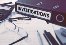 Documents and binder labeled Investigations on desk
