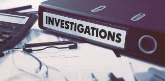 Documents and binder labeled Investigations on desk