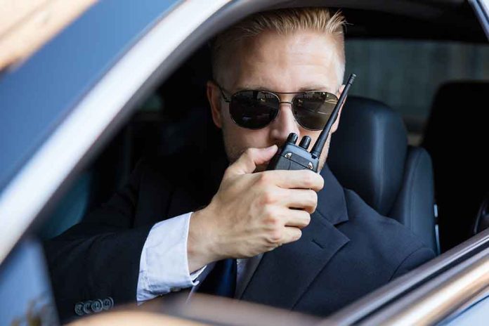 561916870 featured image Man in suit using walkie-talkie in car