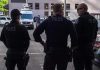 Three police officers standing on a city street