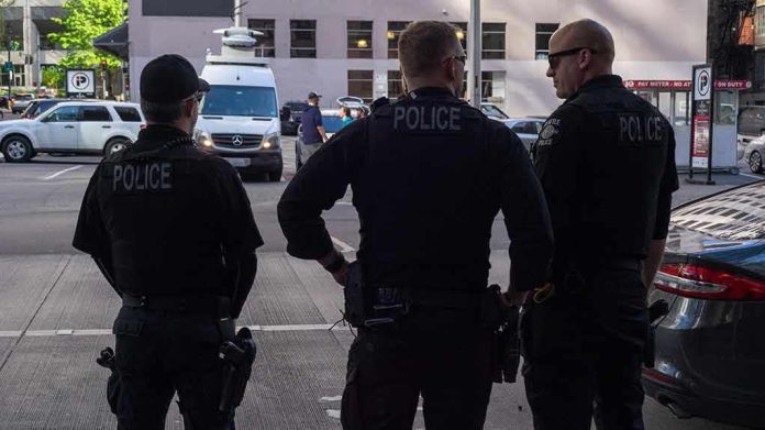Three police officers standing on a city street