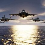 Five jets flying low over the ocean at sunset