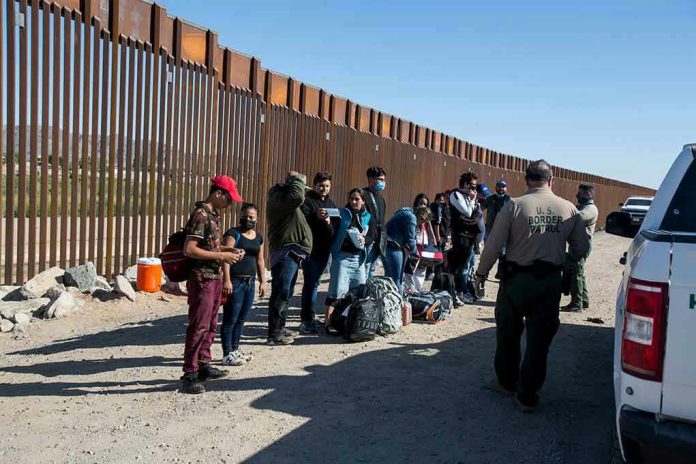 1973414822 Border patrol agents interact with a group of people