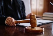 Judge holding gavel in courtroom