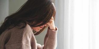 Person with head down, looking distressed or contemplative