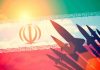 Silhouettes of missiles over Iran's flag graphic