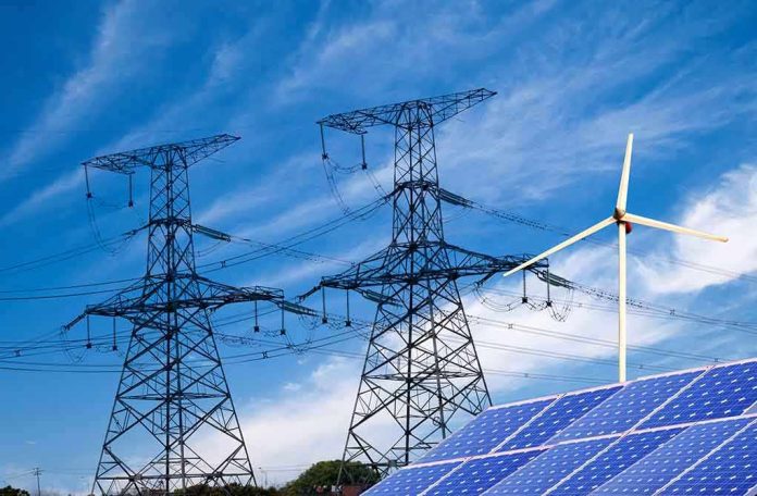 shutterstock_138865700.jpg Solar panels and a wind turbine with power lines against a blue sky