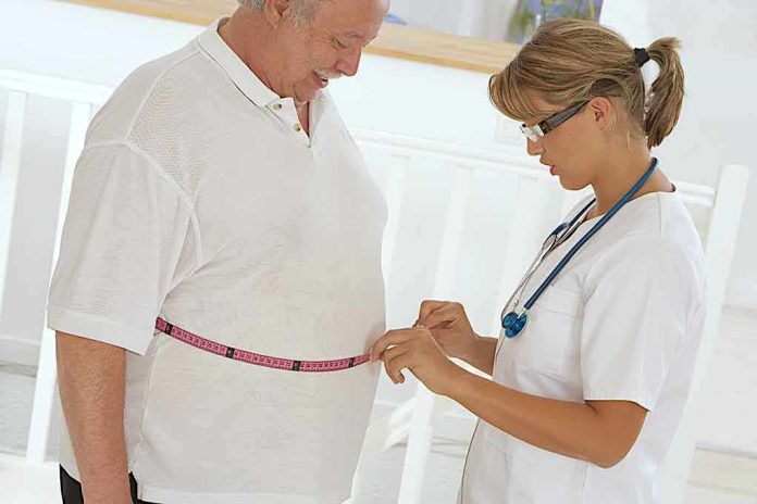 A healthcare professional measuring a patient's waist with a tape measure