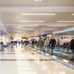 People walking through a busy airport terminal