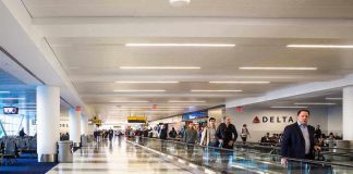 People walking through a busy airport terminal