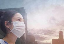 Person wearing a mask in a cityscape background.