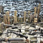 Room filled with various firearms and ammunition belts.