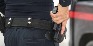 Person holding a gun in a holster