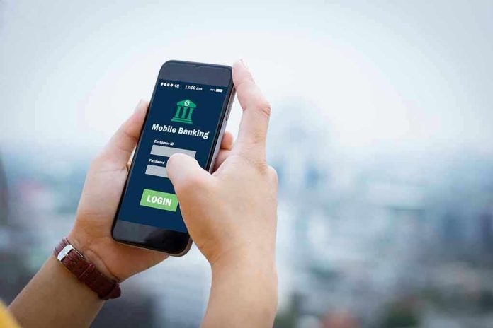 564088018 Person using mobile banking app on smartphone.