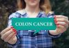 Person holding colon cancer sign in hands