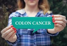 Person holding colon cancer sign in hands