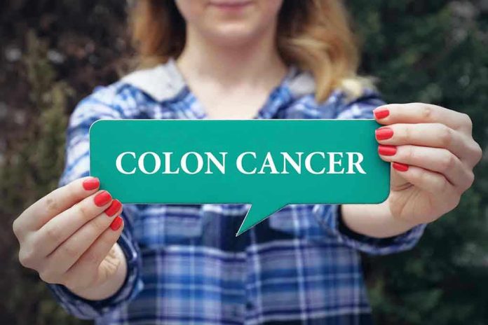 601344959 Person holding colon cancer sign in hands