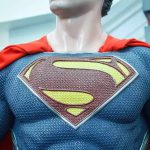 Close-up of a Superman statue wearing a blue costume and red cape