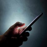 Sleepless Gen Z Trap—VICIOUS Cycle Exposed Hand holding a smartphone in the dark