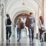 U.S. Students Pushed Aside—Outrage Erupts! Four students walking in a corridor together