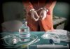 Vial labeled Sodium Thiopental near handcuffed person.