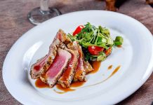 Plated seared tuna with a fresh salad on the side