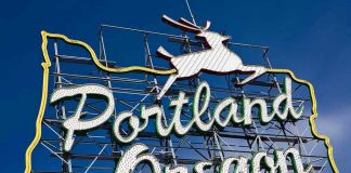 Portland Oregon neon sign with leaping deer outline