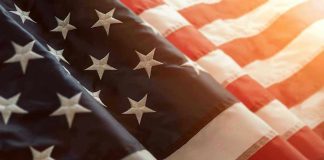 Close up of American flag with sunlit background