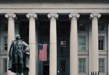 US Treasury Department building with statue and flag