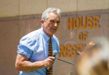 Man speaking outside House of Representatives building