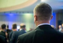 Man with earpiece at a crowded event