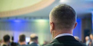 Man with earpiece at a crowded event