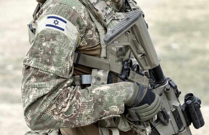 1917131027 Soldier in camouflage gear with Israeli flag patch
