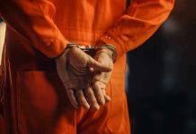 Trump Targets Cartels With Terror Tools Person in orange jumpsuit with handcuffs behind back