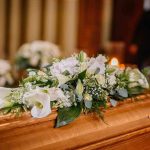 Fatal Affair ROCKS Washington Flower arrangement on a wooden casket at a funeral