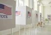 Voting booths with American flag and VOTE signs