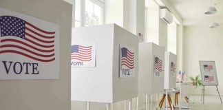Voting booths with American flag and VOTE signs