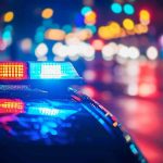 Police car with flashing lights at night