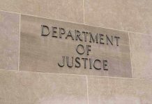 $230M Demand Stirs Unprecedented DOJ Conflict Department of Justice sign on a building