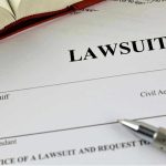 Digital Danger: Families Exposed to AI Exploitation Lawsuit document with a pen and book