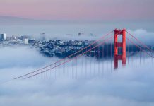 Golden Gate Bridge emerging from fog with San Francisco in the background