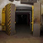 Switzerland’s $250 Million Gamble—What’s Hiding Underground? Entrance to an underground bunker with large heavy doors and a sign
