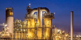 An industrial facility with illuminated structures at night